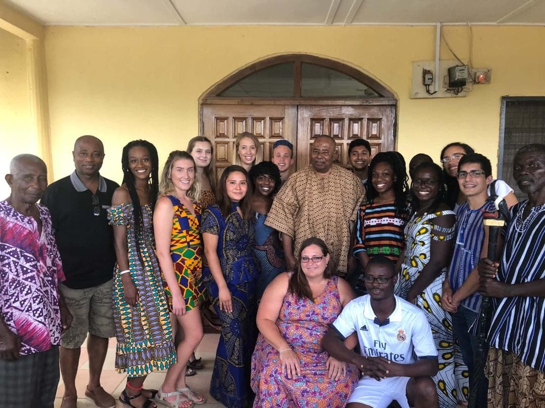 A visiting volunteer group with staff and community elders