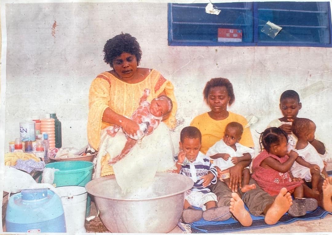 Mrs. Emma Boafo Yeboah caring for a child in the early years of the home